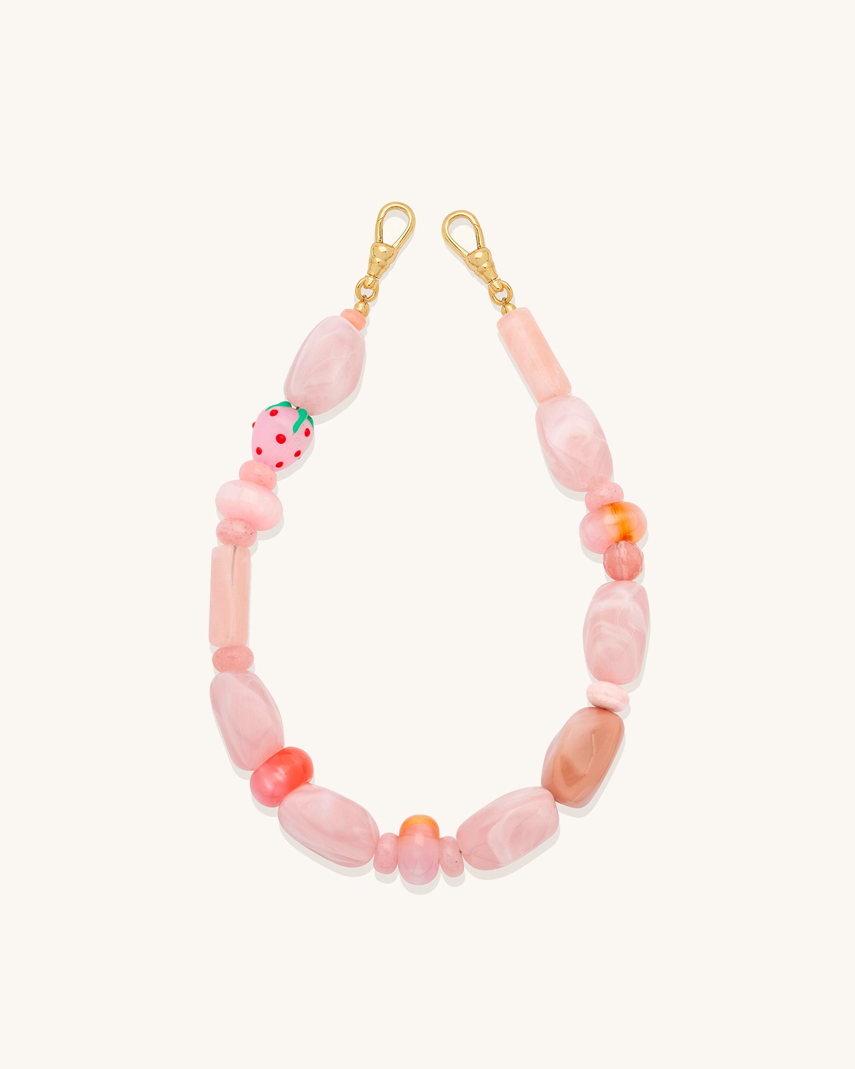 Wristlet with pink and orange beads on a white background