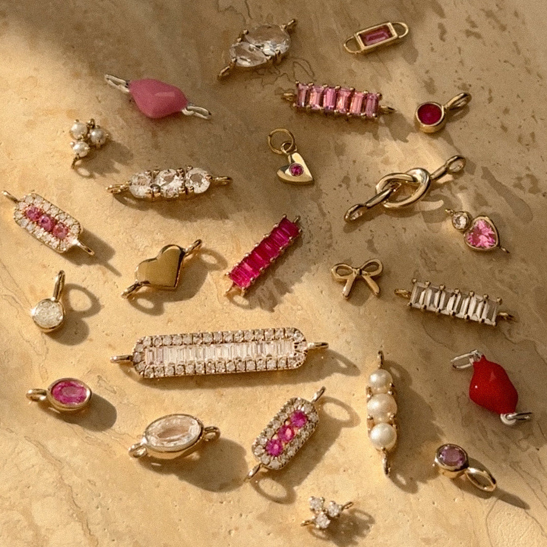 Collection of welded jewelry connector charms in gold and pink